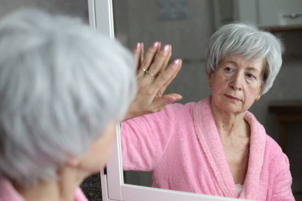 istock Senior woman touching her mirror reflection 1481909447