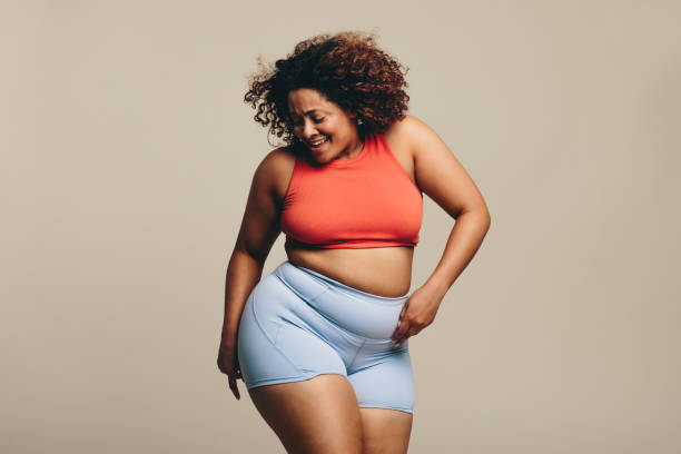 istock Confident plus size woman celebrating her body with a dance 1481917748
