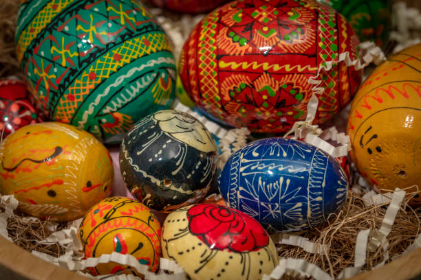 istock Color easter eggs in light wooden bowl on blue old wooden table 1481917965
