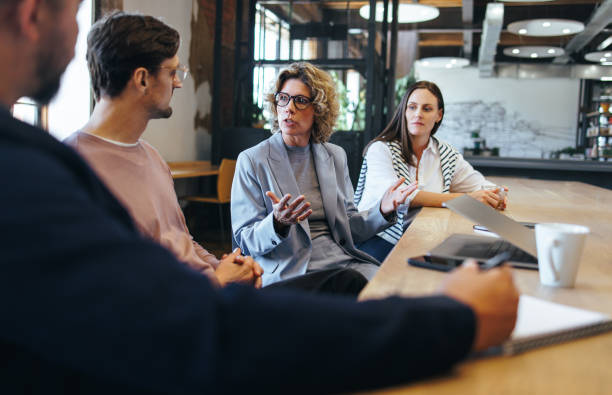 istock Team of professionals talking about a project in a meeting 1481918248
