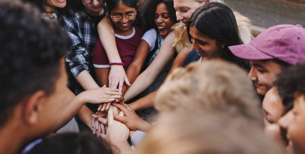 istock Multicultural teenagers putting their hands together 1481918510