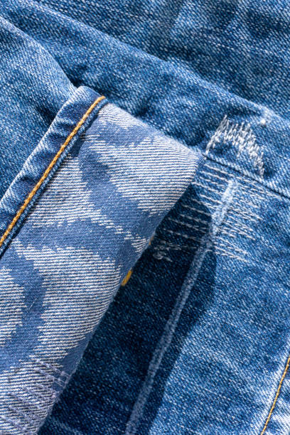 istock Blue jeans with patterns on the cuffs and decorative seams close up 1481926321