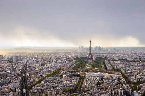 Eiffel tour between the old buildings in the street of Paris, France