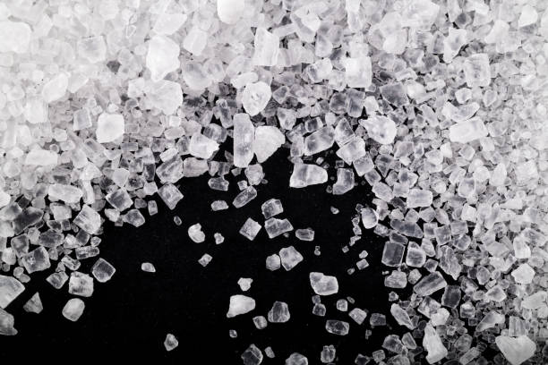 istock Sea salt grains on the black background. 1481927424