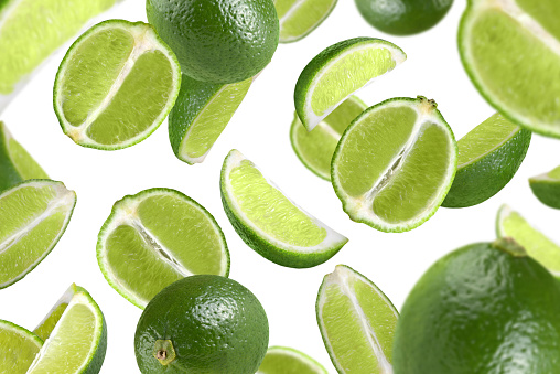 Levitation of lime slices isolated on white background.