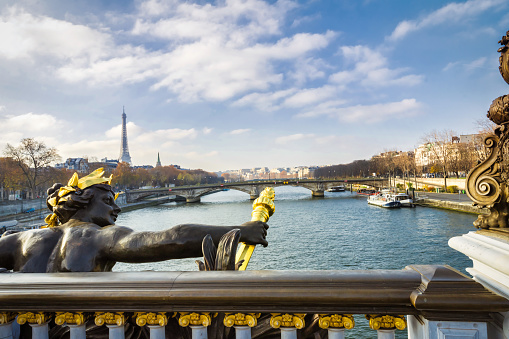 bridge Pont Alexandre III  over the seine river with eiffel tower in the background at sunny day