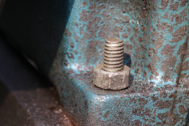 istock Mild steel nut and bolt are fitted on a cast iron engine block base. Fastener with a view of threads 1481936770
