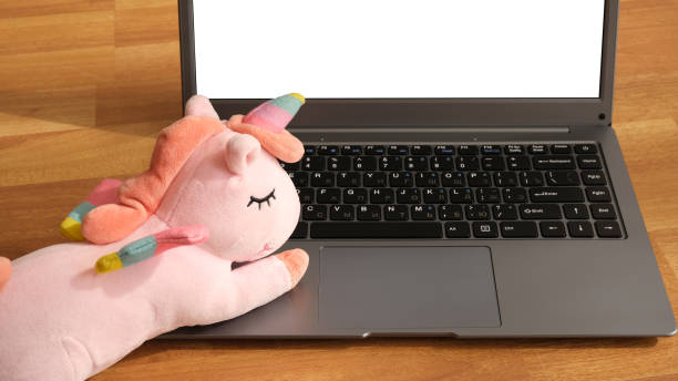Toy unicorn on laptop keyboard.