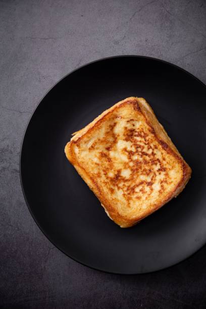 istock Appetizing grilled cheese toast sandwich displayed on a black plate, ready to be enjoyed 1481946683