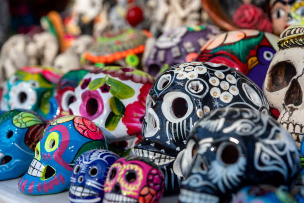 istock Handmade clay skulls painted in different colors. A clay skull is a skull or skeleton figure commonly used for decoration during the Day of the Dead in Mexico. 1481947741
