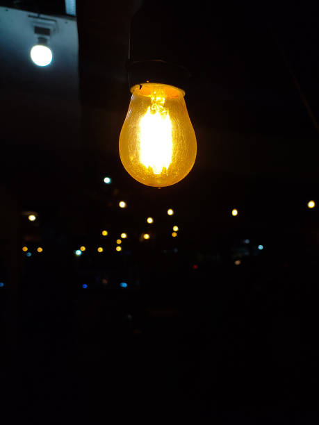 istock Yellow light bulb in a blurry and dark background 1481948517