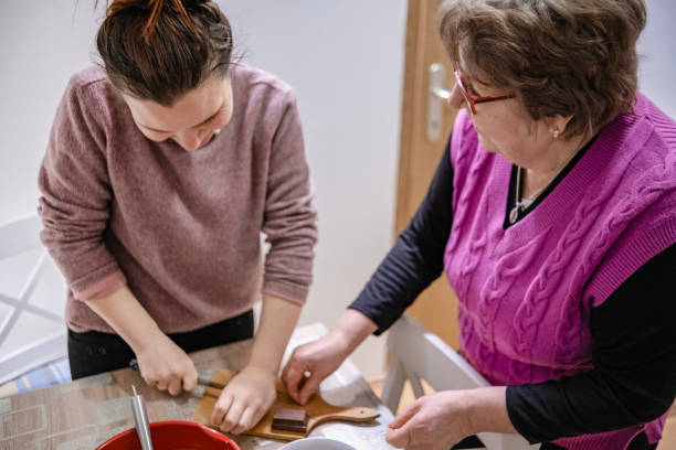 istock Multi-generational family working together making muffins 1481953444