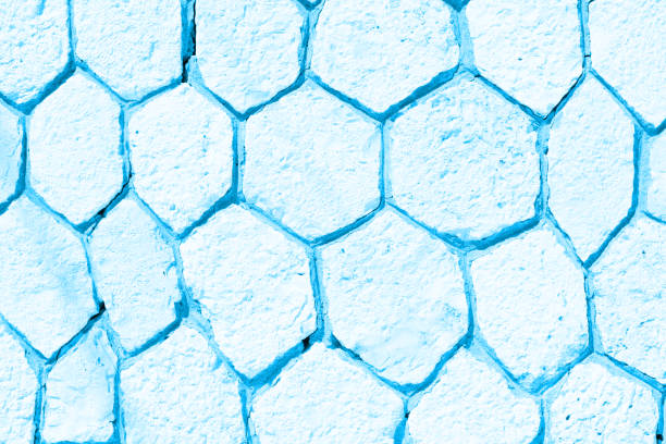 Empty wall made of rocky hexagons in blue tone. Background with copy space, banner