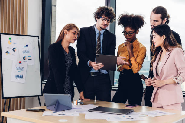 istock Diverse colleagues gather in brainstorm discuss statistics together. 1481956113