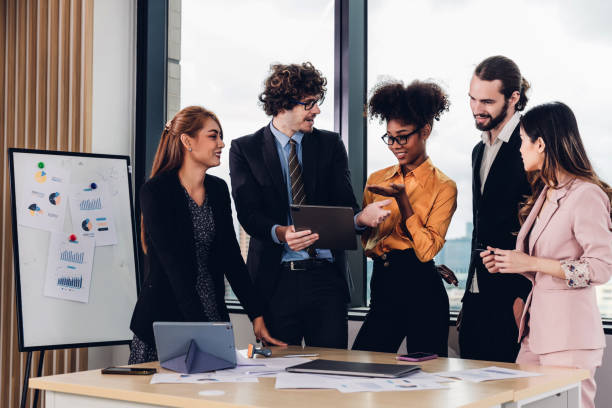 istock Diverse colleagues gather in brainstorm discuss statistics together. 1481956140