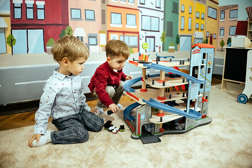 Two boys in a preschool play together