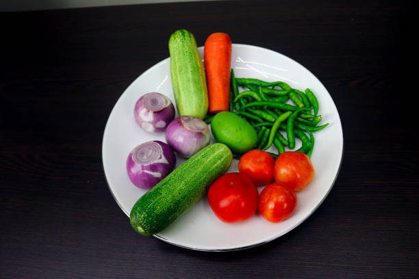 Assorted vegetables viewed from above, over a white background