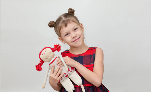 istock Happy and smiling child hugging doll toy on white background 1481972206