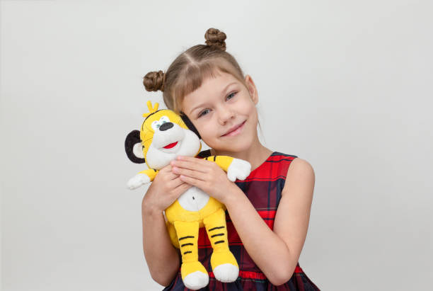 istock Happy and smiling child hugging tiger toy on white background 1481972218