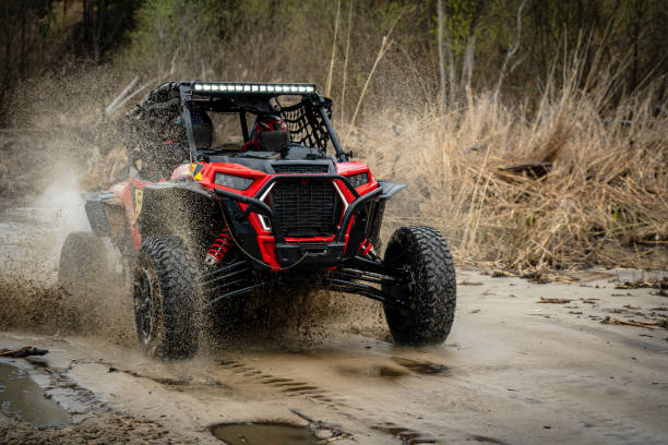 istock ATV/UTV/4x4 driving throw splashing past a muddy large puddle in forest 1481972614