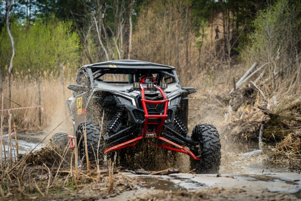 istock ATV/UTV/4x4 driving throw splashing past a muddy large puddle in forest 1481972664