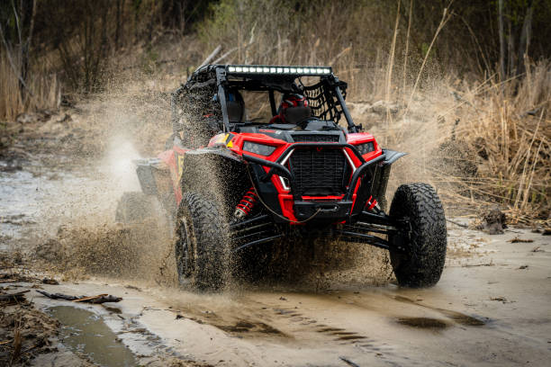 istock ATV/UTV/4x4 driving throw splashing past a muddy large puddle in forest 1481972682