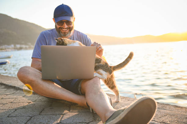 mature adult man working on the beach ( laptop)