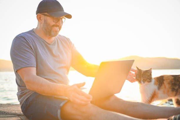 istock mature adult man working on the beach ( laptop) 1481977004