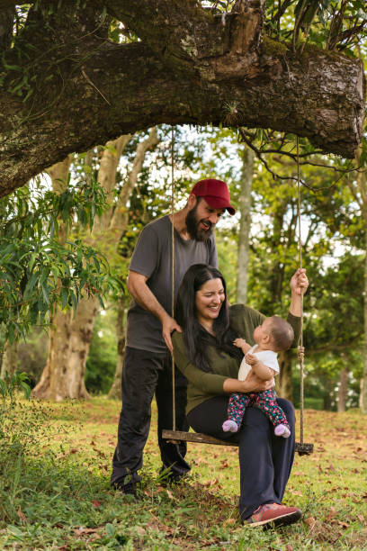 família feliz, pai e mãe sorrindo e olhando para menina, ao ar livre. - women heterosexual couple love men - fotografias e filmes do acervo