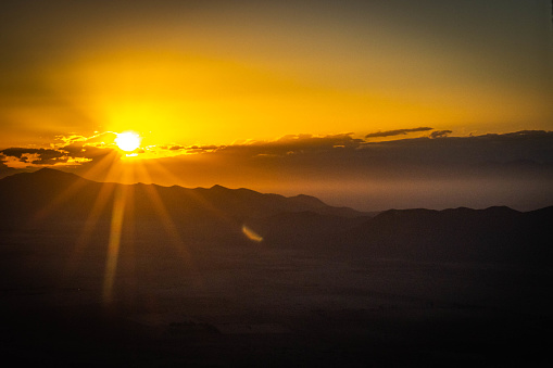 aerial view over Marrakech and High Atlas mountains from hot air balloon at sunrise