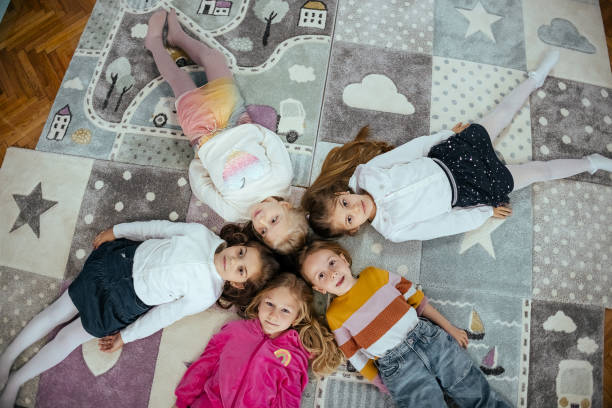 istock Happy group of children lying down 1481981875