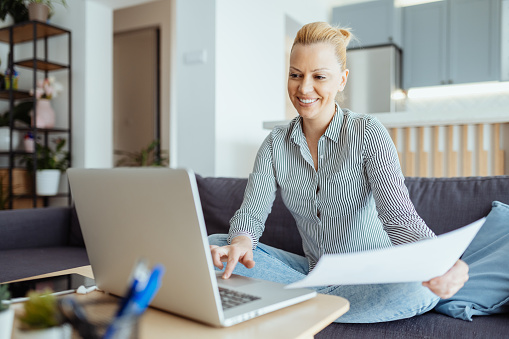 Female entrepreneur or freelance worker doing business from couch