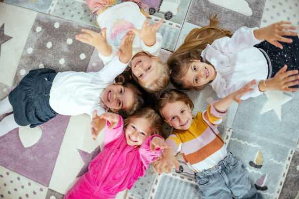 istock Happy group of children lying down 1481983208