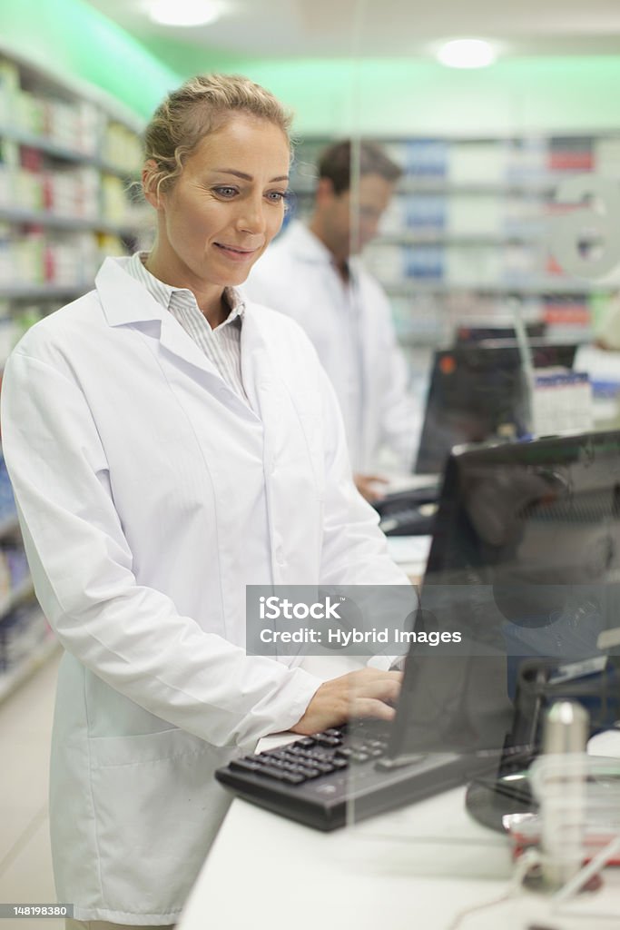 Pharmacist Computer Pharmacist Using Computer At Counter Stock Photo - Download Image Now ...