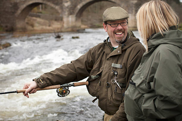 Couple fishing for salmon in river  fly fishing scotland stock pictures, royalty-free photos & images