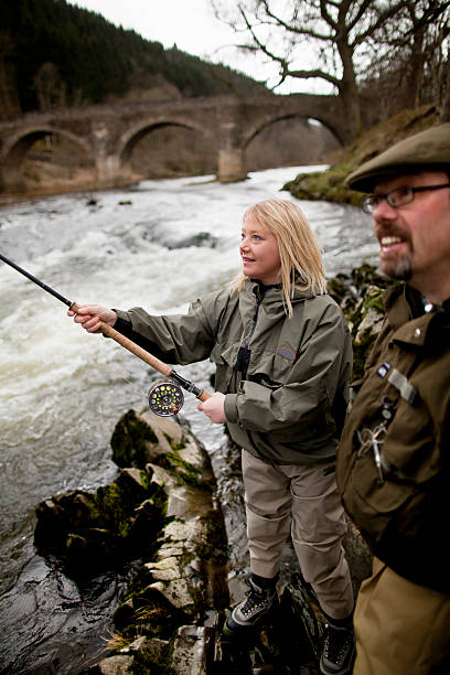 Couple fishing for salmon in river  fly fishing scotland stock pictures, royalty-free photos & images