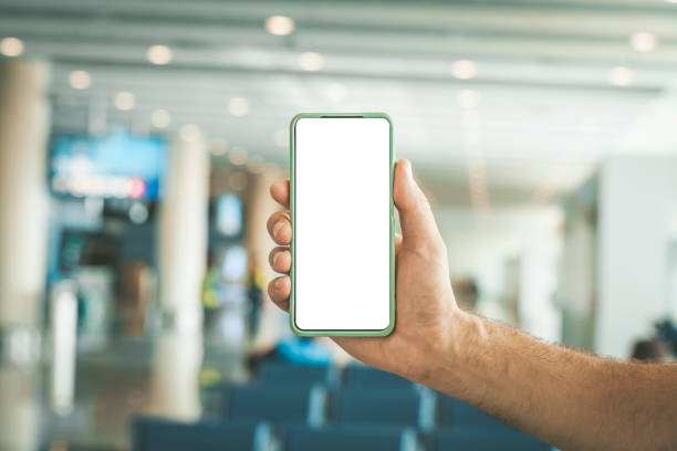 istock Using phone in travelling. Blank screen smartphone at the airport before the flight. Application for travel, banking, concept. 1481990166