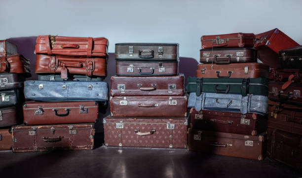 istock Old suitcases of different sizes and colors, stacked. 1481992870