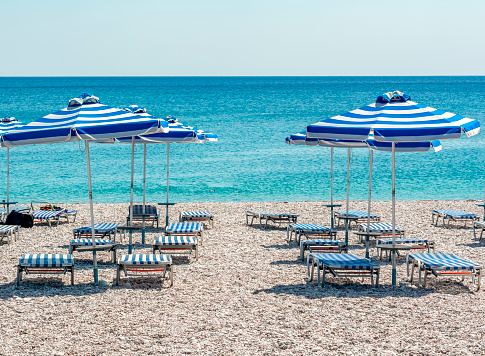 Umbrellas and sunbeds on Traganou beach, Rhodes island, Greece