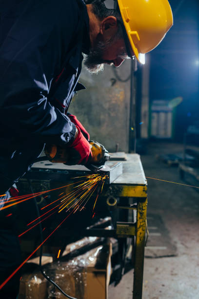 istock Skilled industrial worker grinding metal part. 1481999664