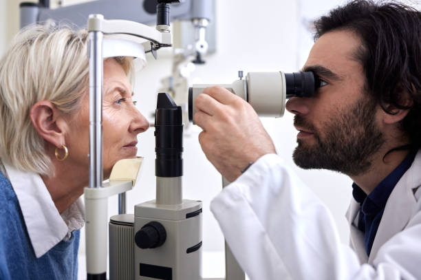istock Optometry, machine exam and woman with an optometrist for a vision check, eye consultation and test. Healthcare, help and male optician with a senior patient to measure visual eyesight with equipment 1481999748