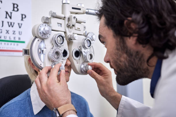 istock Eye exam, test and patient with doctor for vision at optometry consultation for lens or frame. Woman and man in healthcare with machine for eyes with health insurance and expert ophthalmology care 1481999769
