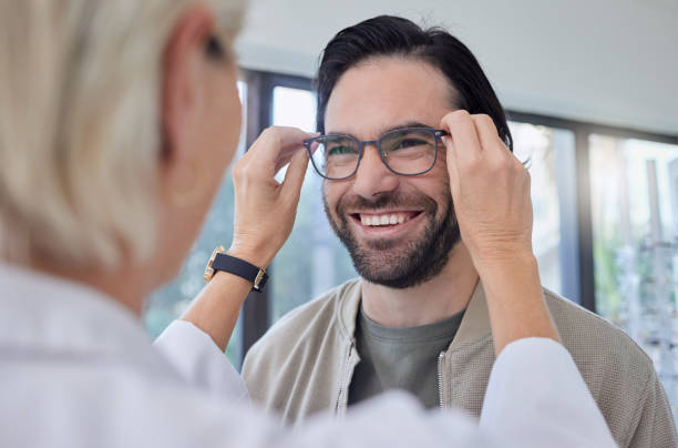 istock Optometrist, glasses and man with smile in store for vision, eyesight and optical frames. Happy customer face, spectacles and prescription lenses for eye care test, consulting or retail shop services 1481999962