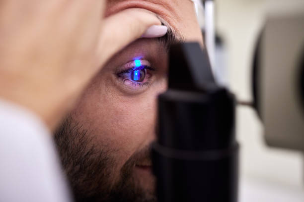 istock Eye exam, vision or laser test for a man with machine at optometry consultation for retina problem. Hands, eyesight or doctor helping or checking a patient or client with medical insurance for health 1482000193