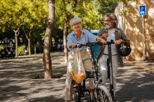 istock Happy senior couple with vehicles. 1482000903