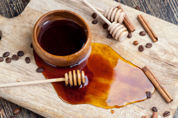 istock sweet natural bee honey spilled on the table 1482002477
