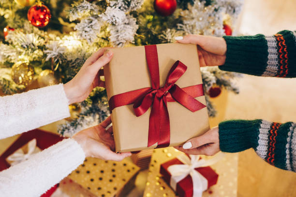 istock Two women exchanging Christmas gifts 1482005006