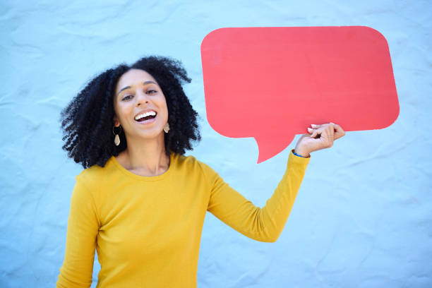 istock Portrait, speech bubble and black woman in studio for advertising, mockup and space on blue background. Face, girl and billboard, branding and paper for product placement, marketing and copy space 1482007708