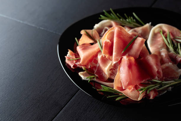 istock Italian prosciutto or Spanish jamon with rosemary. 1482008682