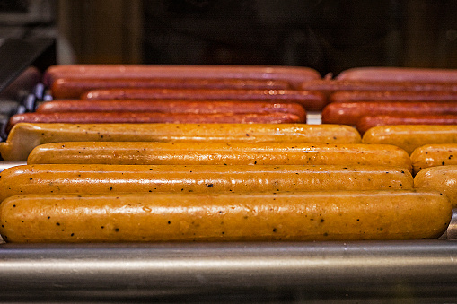 cook wieners and sausages for hot dogs at a gas station, horizontal